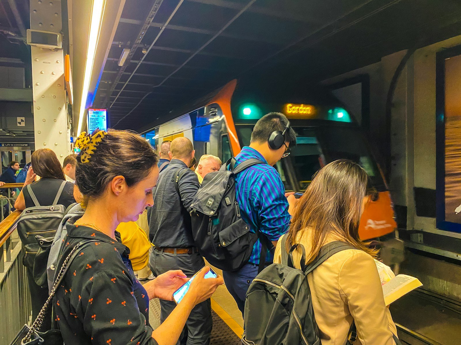 A group of people standing next to each other at a train station
